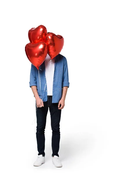 Man with heart shaped balloons — Stock Photo