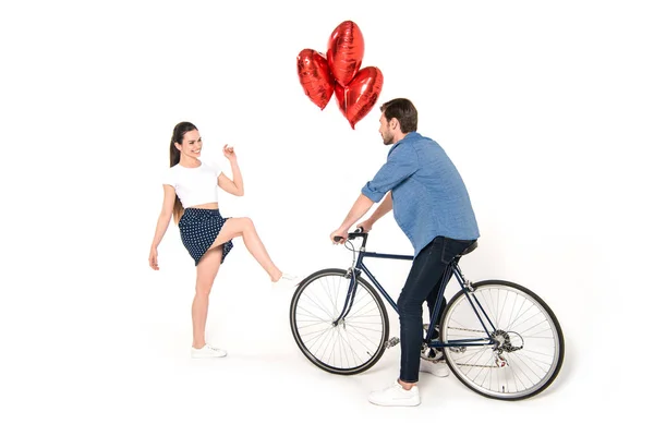 Couple with bicycle and balloons — Stock Photo