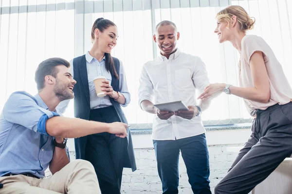 Young business people with digital tablet — Stock Photo