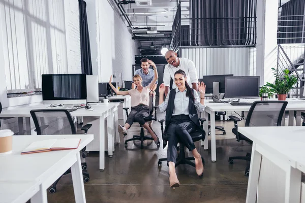 Excited business people on chairs — Stock Photo