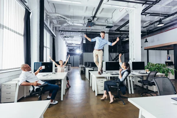Businessman dancing on table — Stock Photo