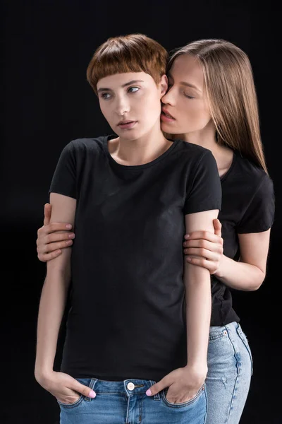 Young woman embracing girlfriend — Stock Photo