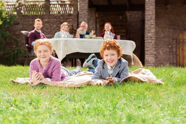 Kids resting on green grass — Stock Photo