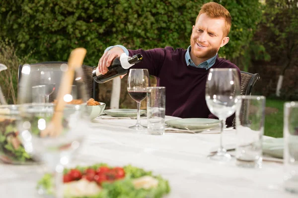 Man pouring wine into glass — Stock Photo
