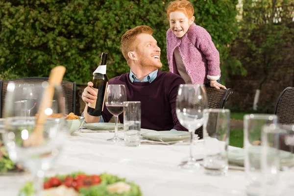 Happy father and daughter at family dinner — Stock Photo