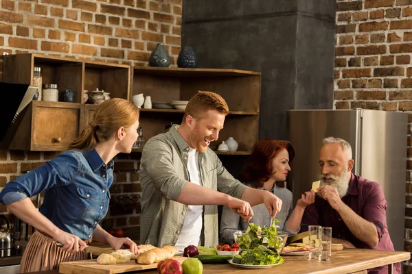 Multigeneration family cooking dinner — Stock Photo