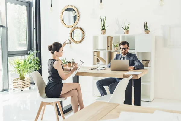 Businessman and secretery working in office — Stock Photo