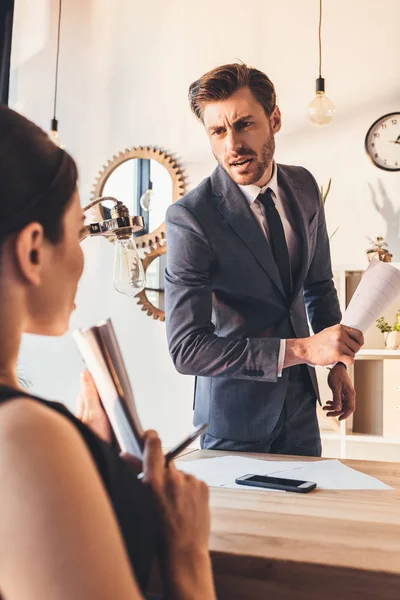 Businessman reprehending secretery — Stock Photo