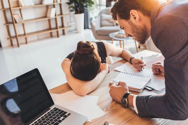 Young secretery crying on desk — Stock Photo