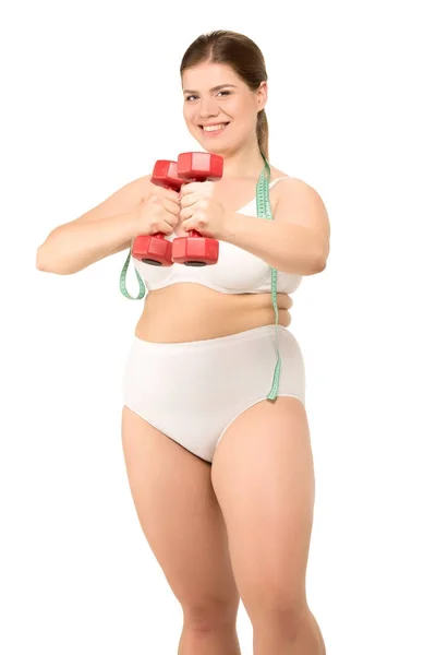 Mujer con sobrepeso y mancuernas - foto de stock