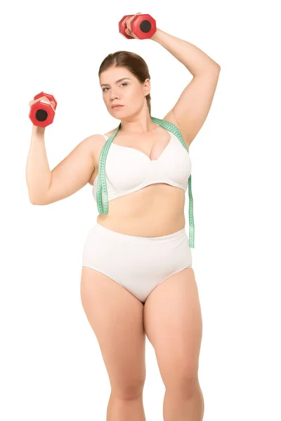 Overweight woman training with dumbbells — Stock Photo