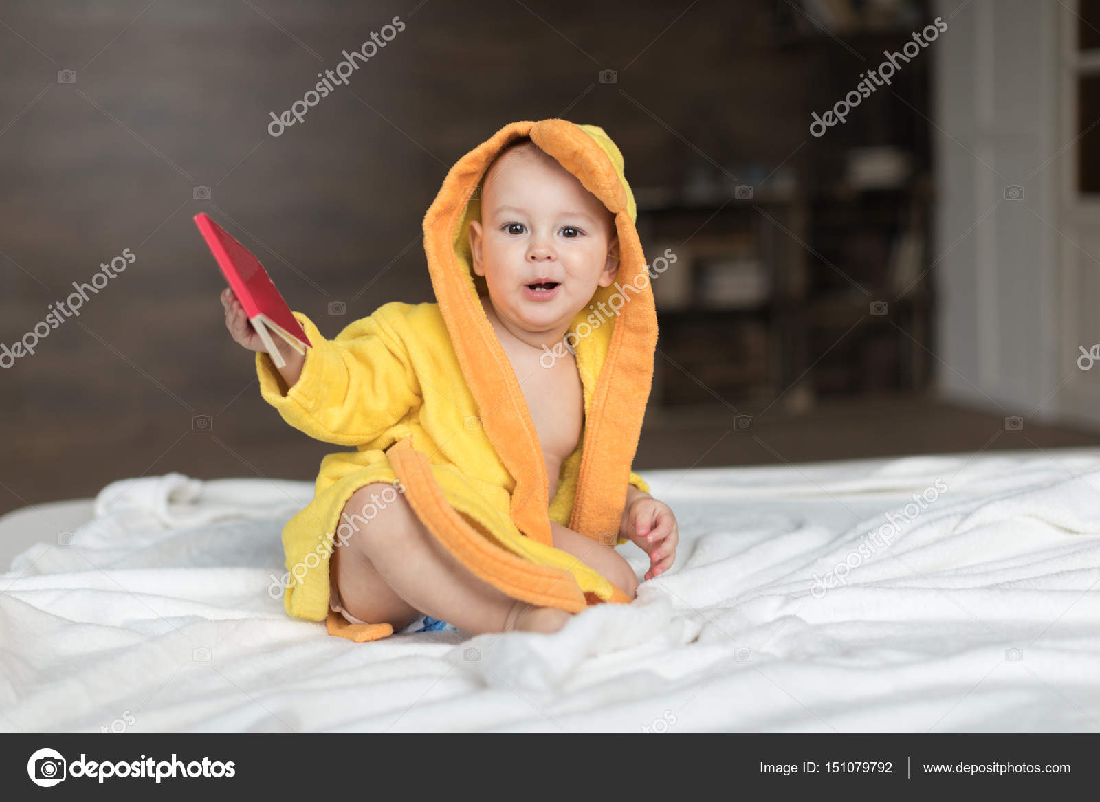 Baby boy in yellow robe — Stock Photo © LenaMiloslavskaya 151079792