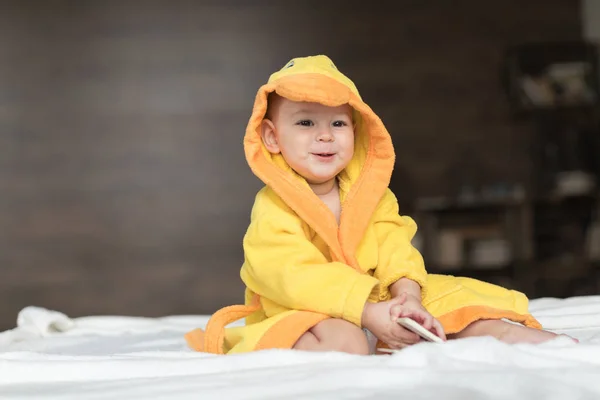 Baby boy in yellow robe — Stock Photo, Image