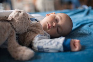 boy sleeping with teddy bear clipart
