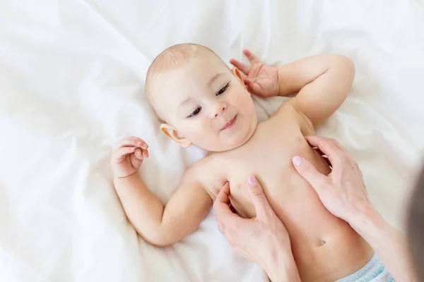 Mother massaging baby — Stock Photo, Image
