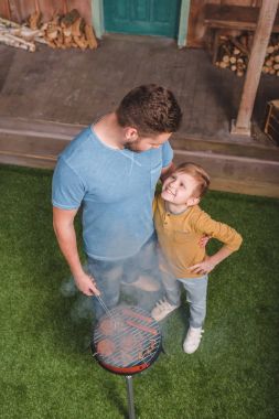 father and son on barbecue clipart
