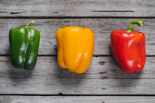 bell peppers laying on wooden table