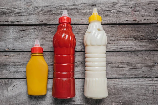 Sauces at bottles on wooden table