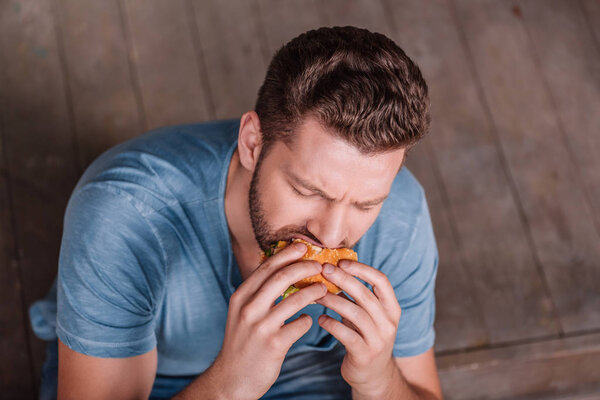 man eating burger