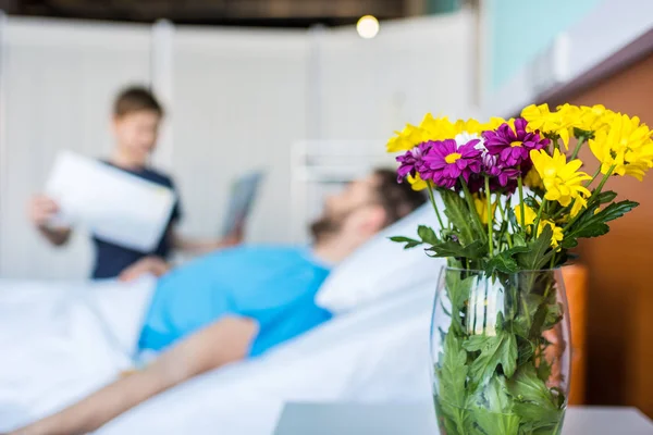 Son showing sick father drawings — Stock Photo, Image