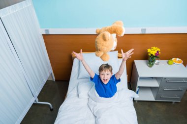 Little boy in hospital bed  clipart