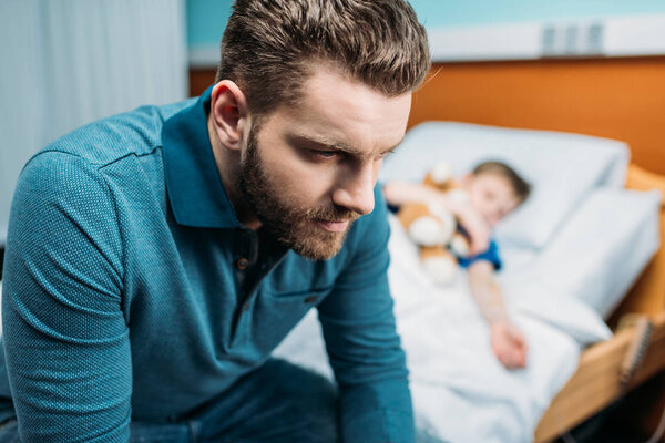 dad near son in hospital bed