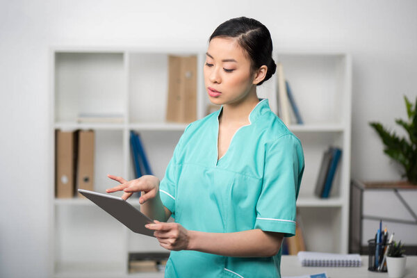 asian internist with digital tablet