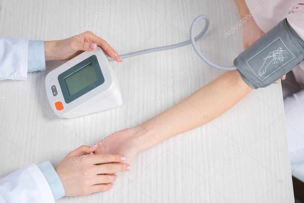 Doctor measuring blood pressure to patient