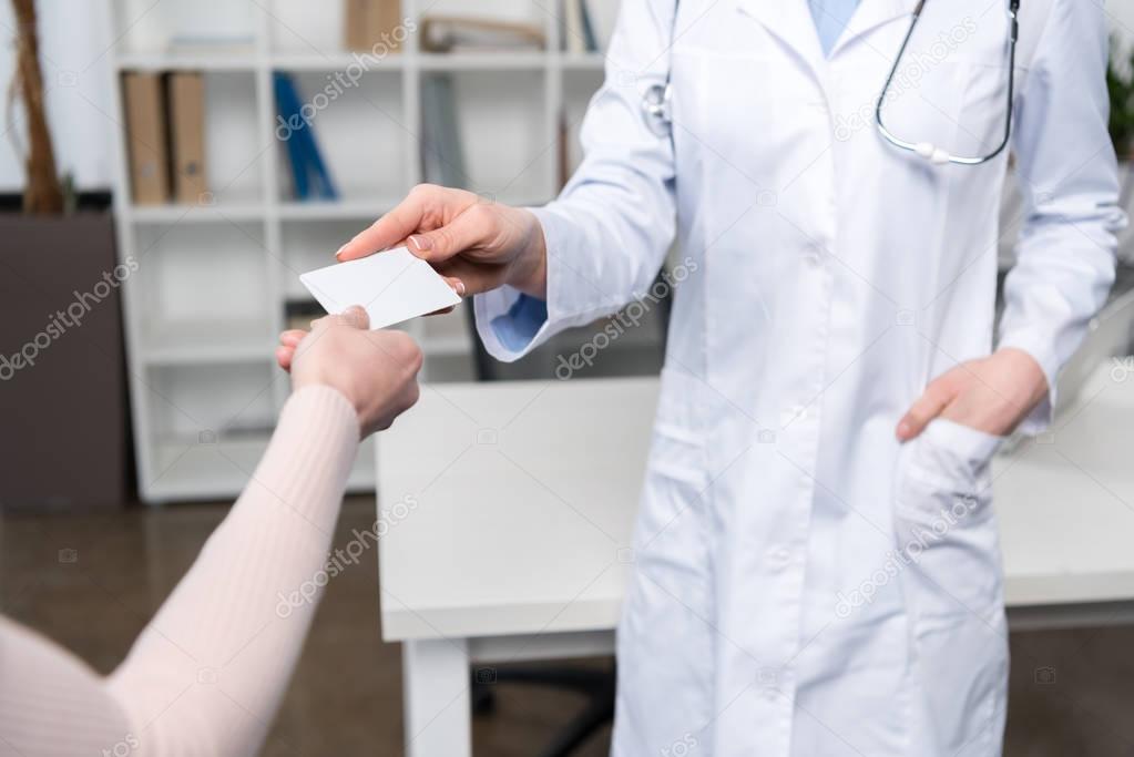 Doctor giving card to patient 