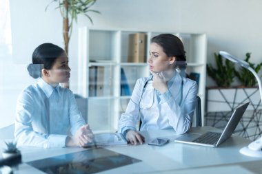 doctor talking with patient at office clipart