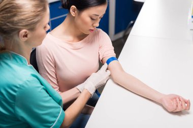 nurse preparing patient to blood analysis clipart