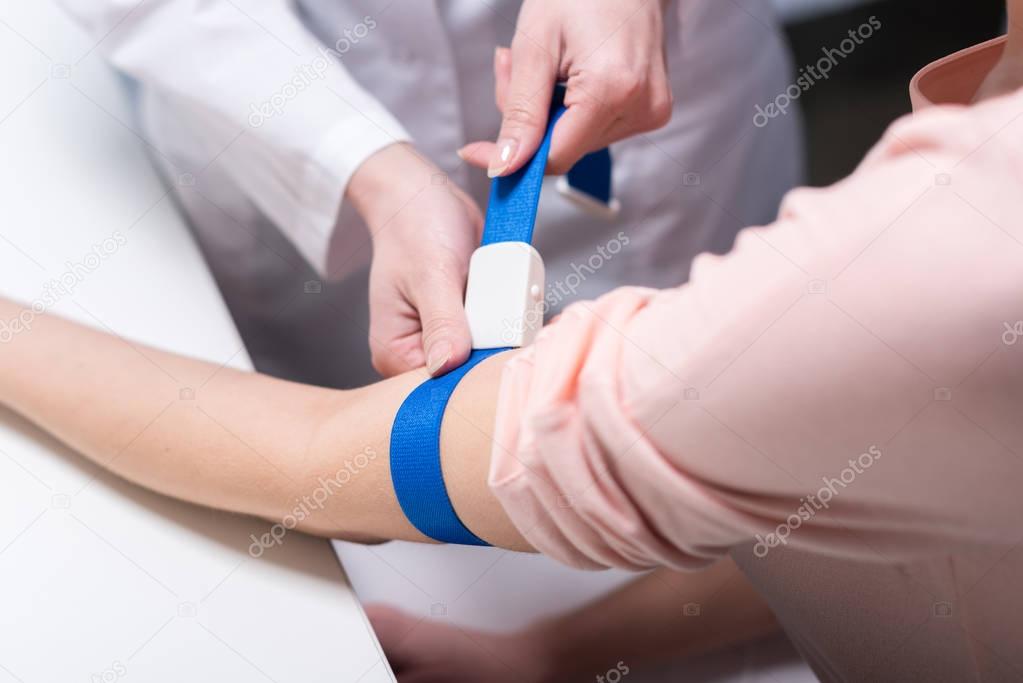 doctor preparing patient to blood test