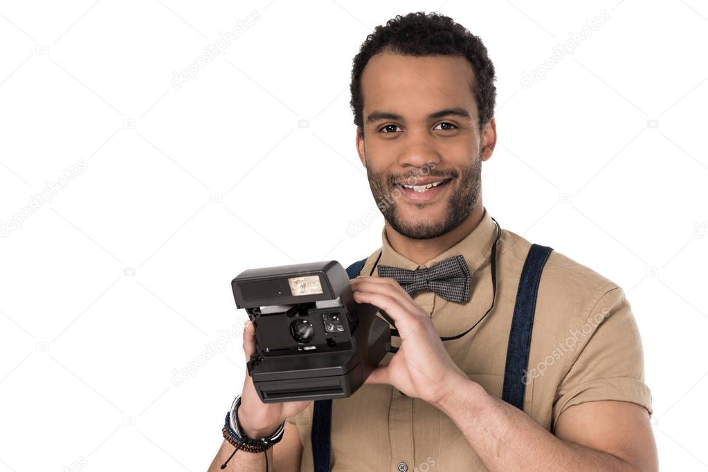 Young man with instant camera 
