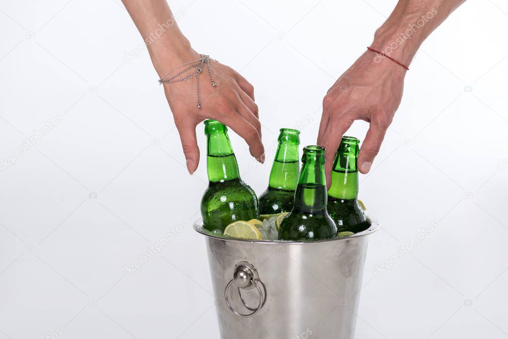 Bucket full of ice and beer bottles 