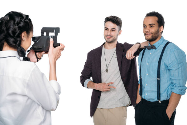 girl taking photo of multiethnic friends