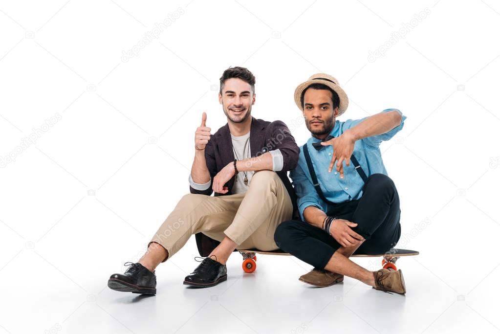 friends sitting on skateboard with hand gestures