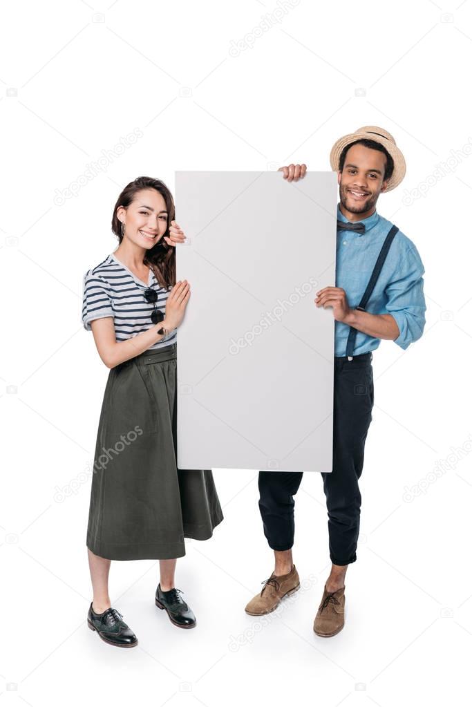 multiethnic friends holding empty banner