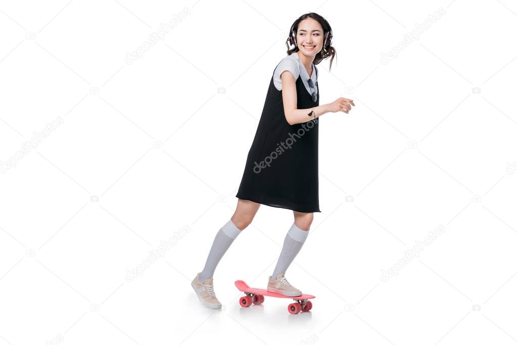 girl listening music and riding on skateboard