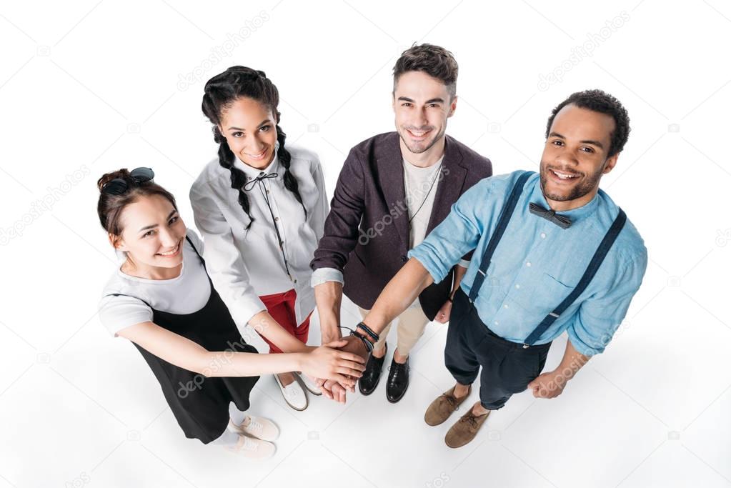 multiethnic friends putting hands together