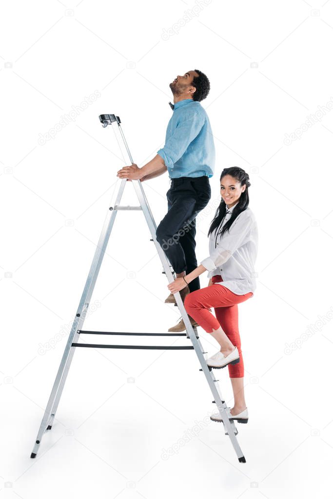 african american couple climbing on stepladder