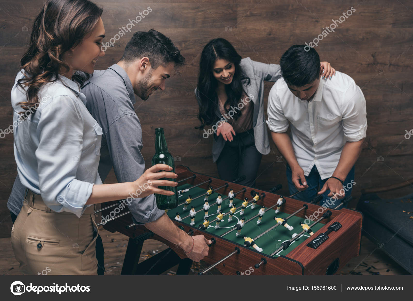 Friends playing foosball Stock Photo by ©AlexLipa 156761600
