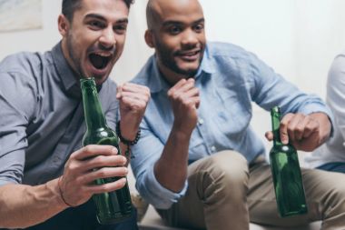 men watching football and drinking beer clipart