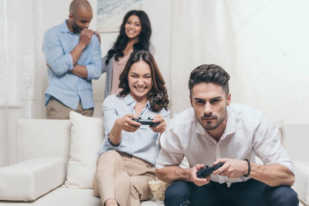 friends playing video games at home