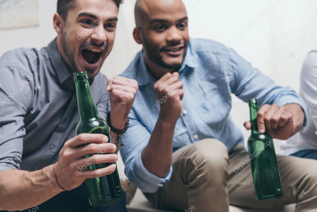 men watching football and drinking beer