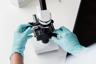 Scientist working with microscope  clipart