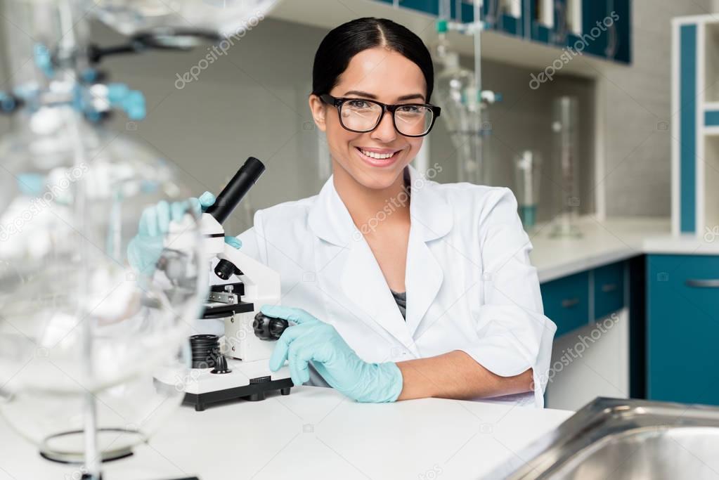 Scientist working with microscope 