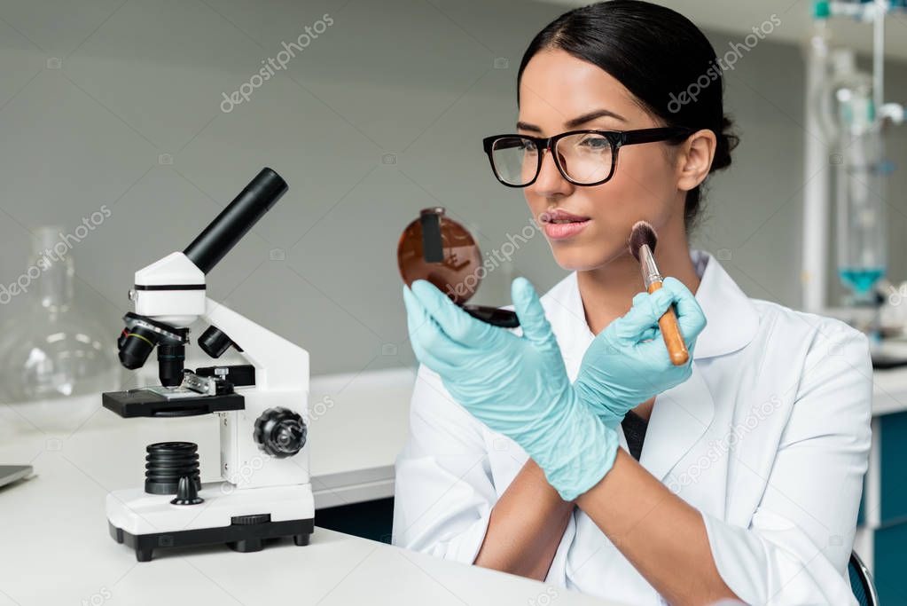 Scientist applying makeup