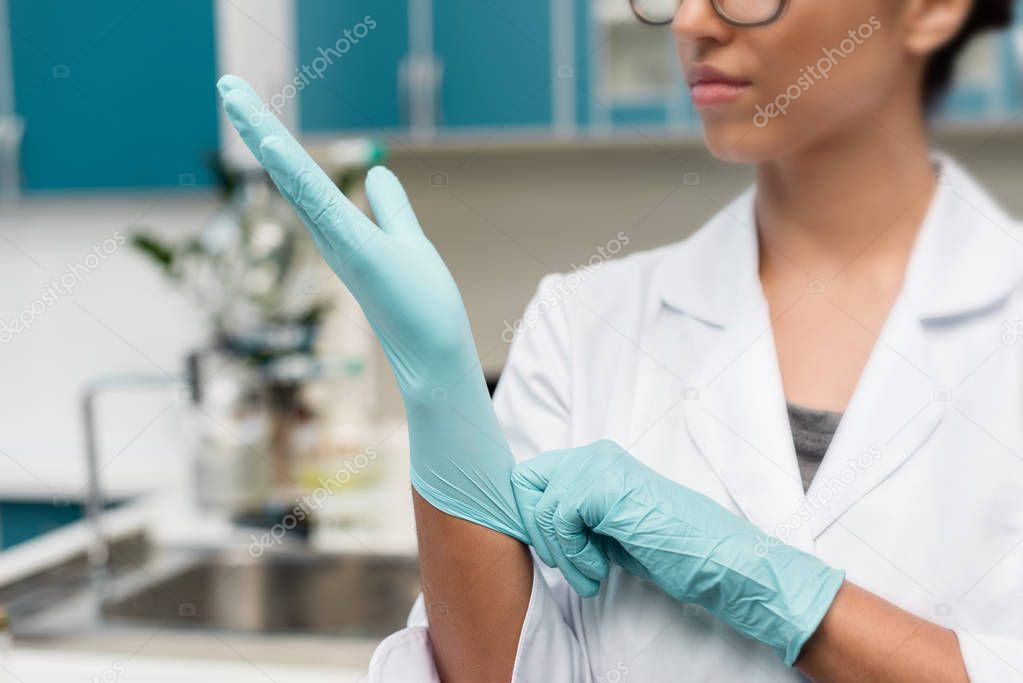 Scientist in protective gloves