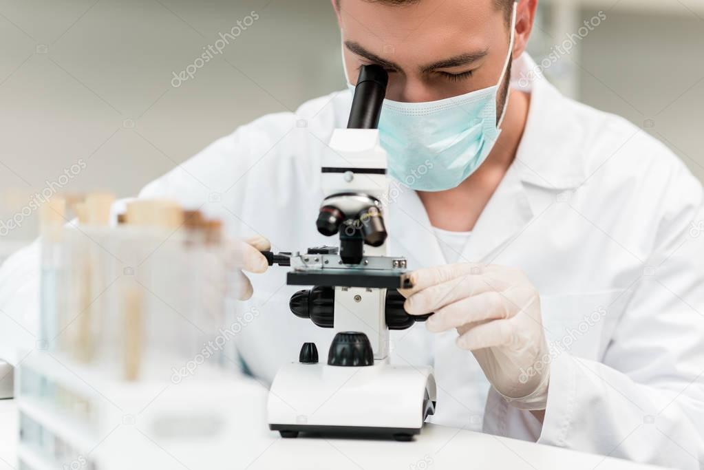 Scientist working with microscope