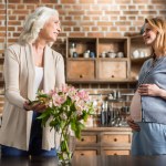 Mujer embarazada y su madre en la cocina